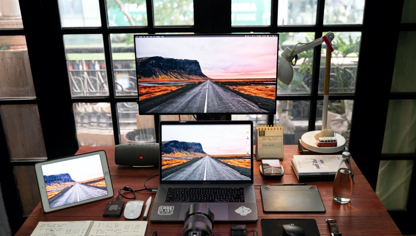 A laptop with SSD installed, connected to two additional screens